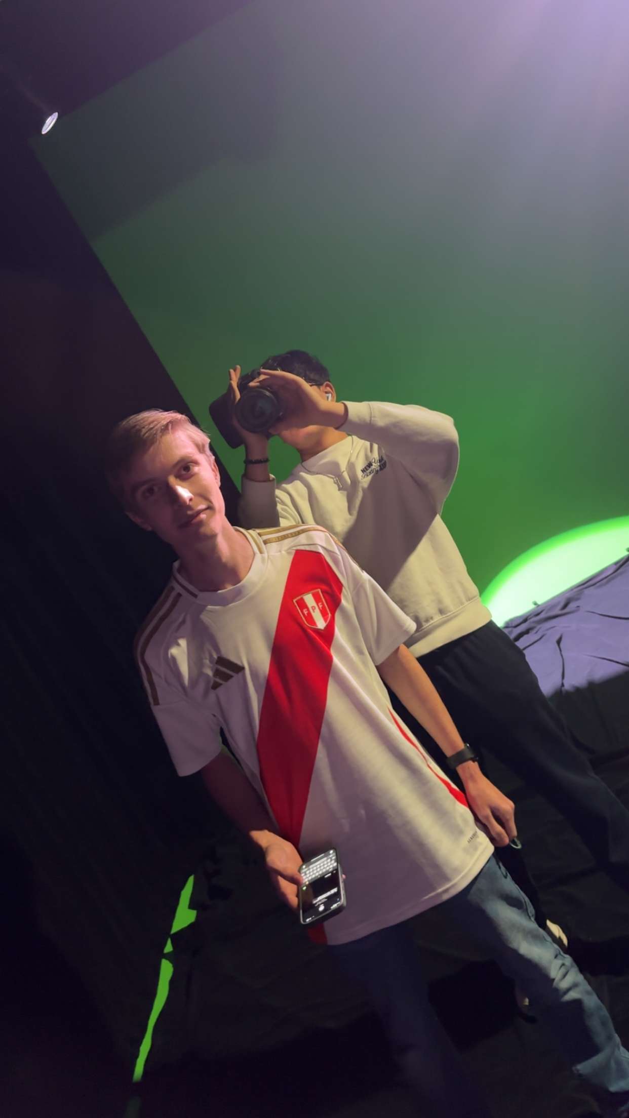 Two individuals, one wearing a jersey, in a stylized indoor setting